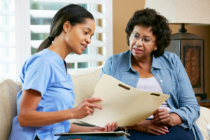 healthcare agent explaining to elderly woman at home